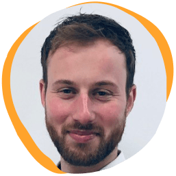 smiling man with short brown hair and beard on a light background, professional headshot with a soft orange circular border