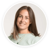 smiling woman with long brown hair wearing a light green shirt, casual portrait in round frame, soft background lighting